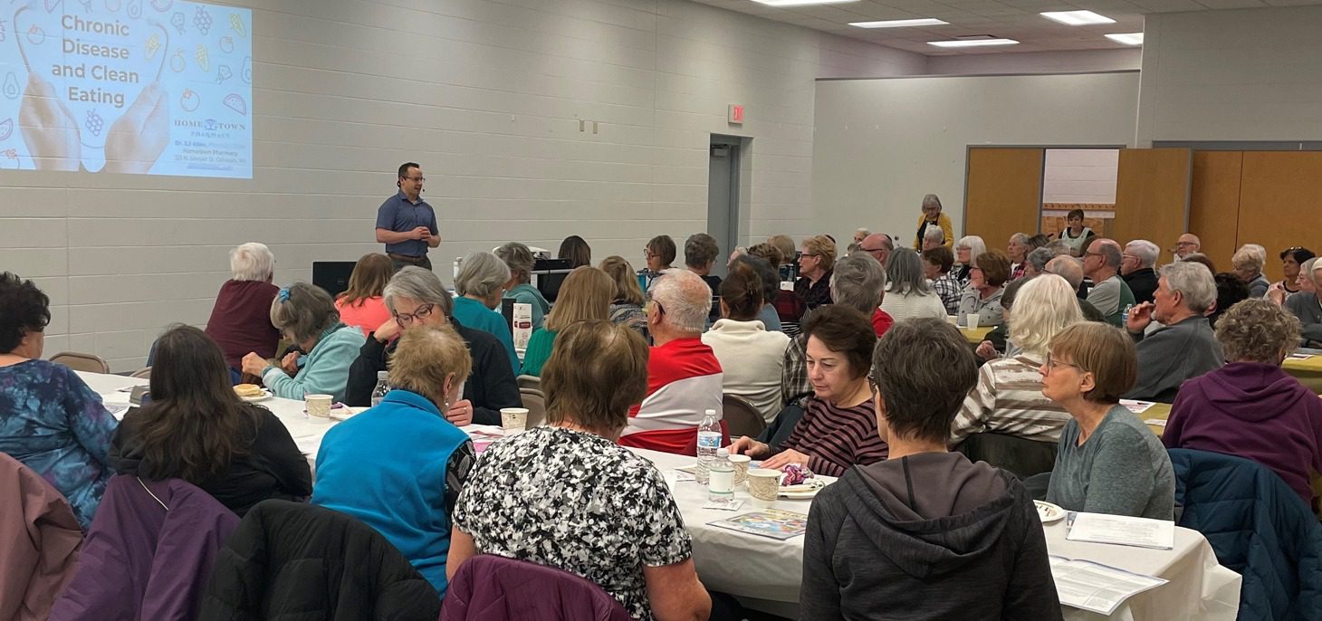 JJ Allen presenting a talk on chronic disease and clean eating to a full room at the Oshkosh YMCA
